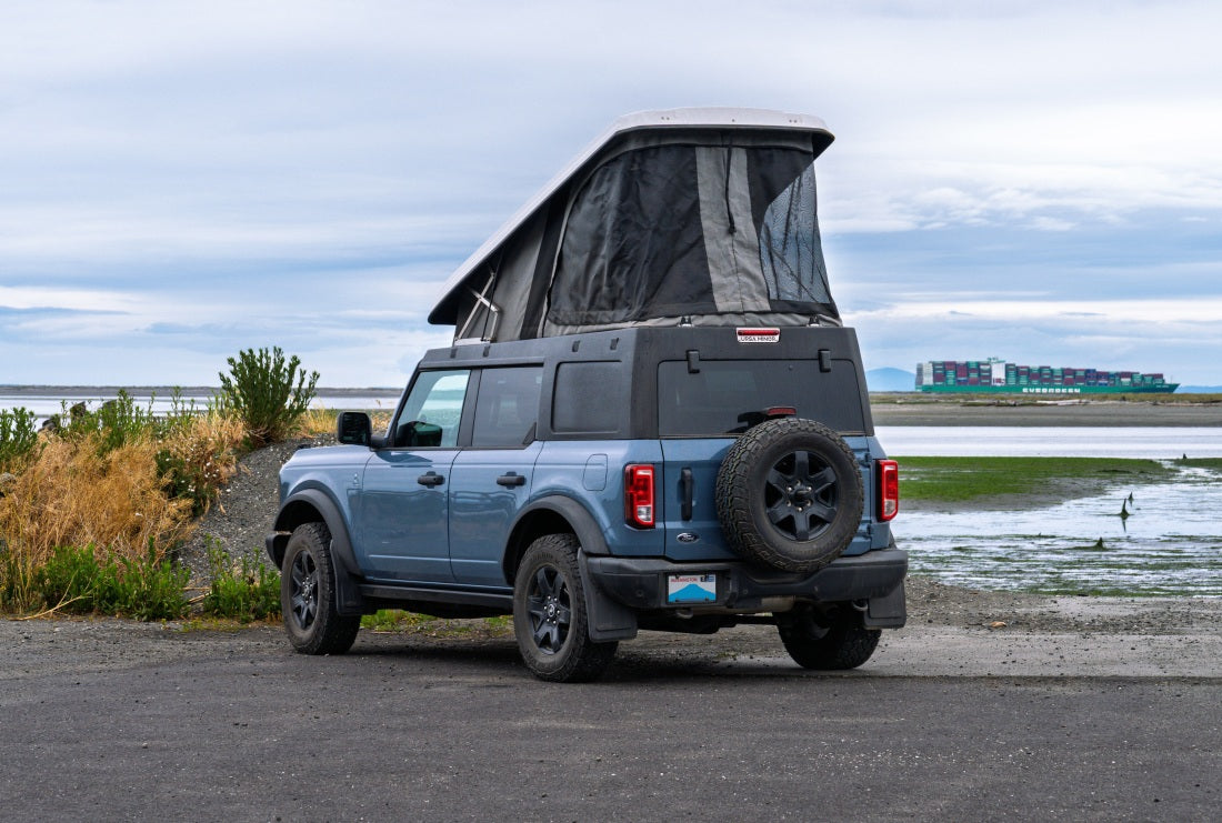Ford Bronco with Ursa Minor Camper by shore